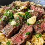 Homemade Garlic Butter Steak Bites over Cheesy Orzo photo