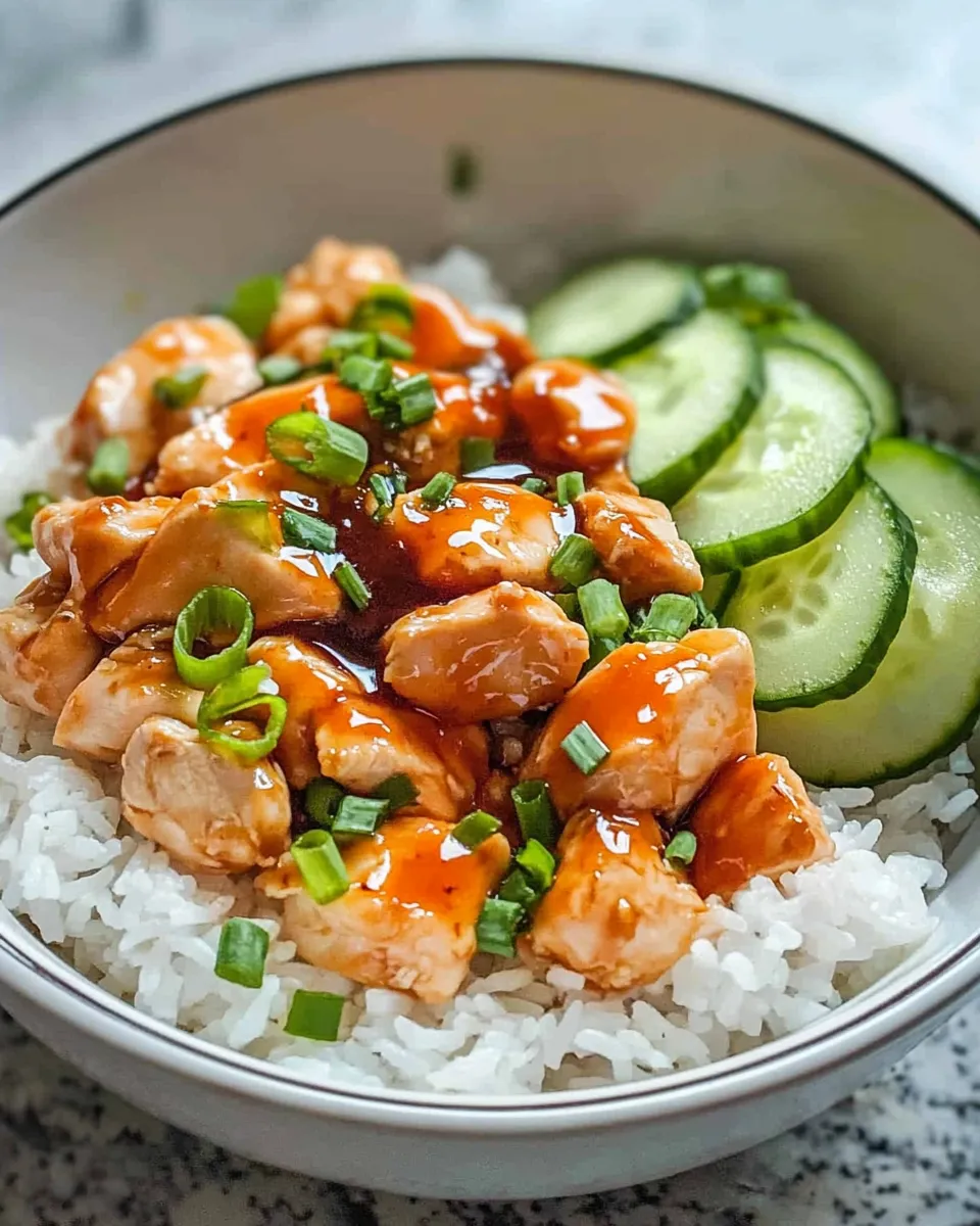 Delicious Hot Honey Chicken Bowls with Rice & Cucumber plate image