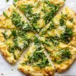 Homemade Crispy Potato & Gruyere Pizza with Arugula. photo